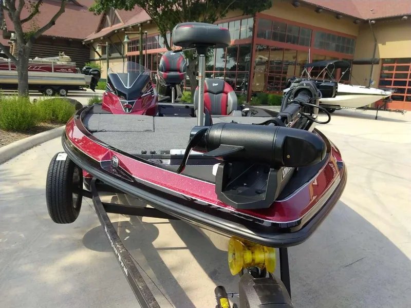 Slide: The Image of 2025 Ranger Z519R Cup-Equipped boat, red, parked outside a building. - 7