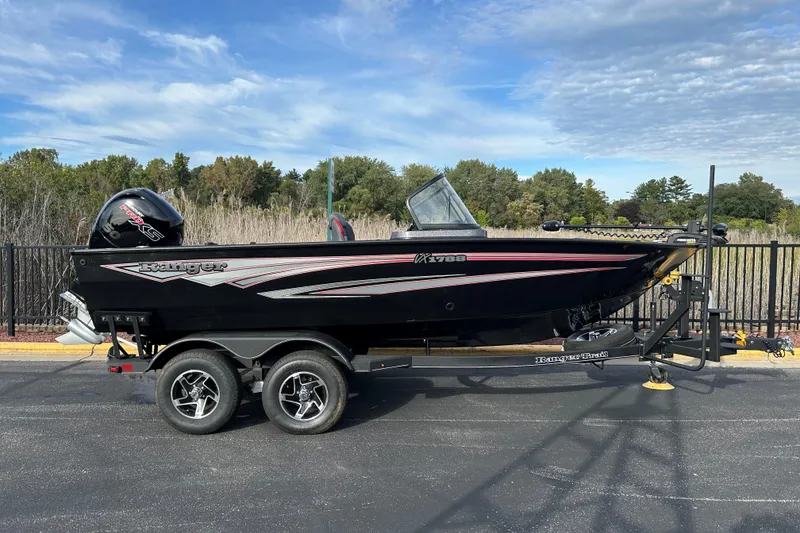 The Image of 2025 Ranger VX1888 WT boat on trailer, parked outdoors under a cloudy sky. - 0