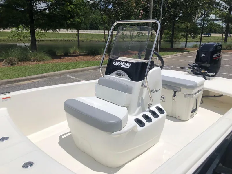 Slide: The Image of 2025 Mako Pro Skiff 15 CC boat with center console and Mercury outboard motor. - 10