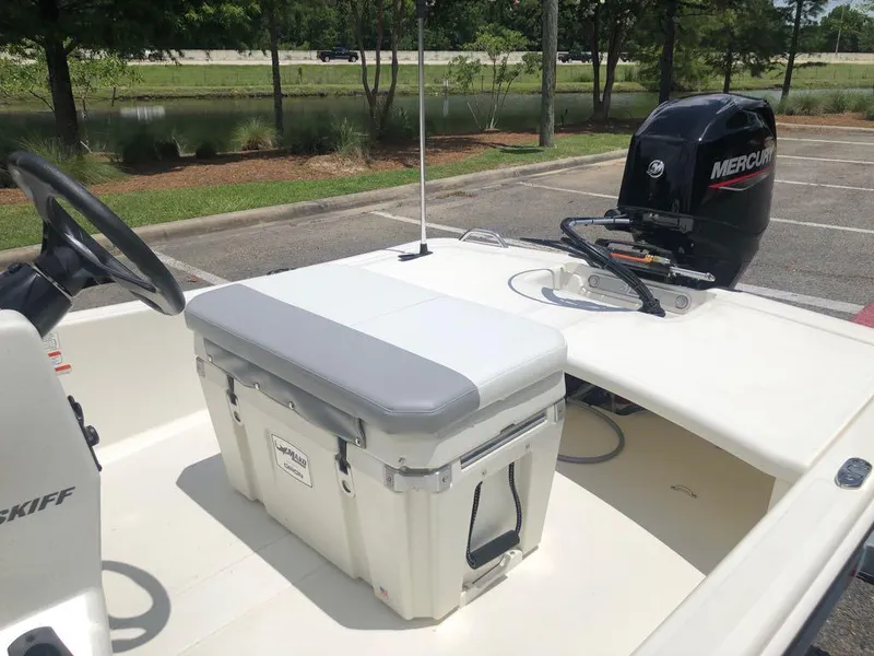 Slide: The Image of 2025 Mako Pro Skiff 15 CC boat with Mercury outboard motor in parking lot. - 12