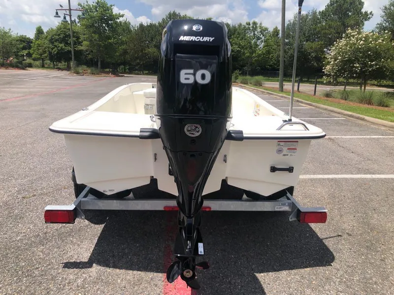 Slide: The Image of 2025 Mako Pro Skiff 15 CC with Mercury 60 engine on trailer in parking lot. - 3