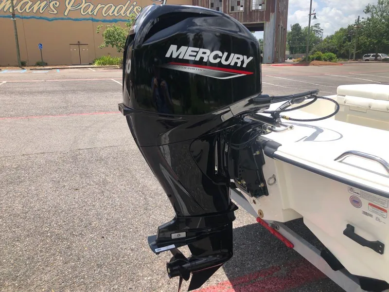 Slide: The Image of 2025 Mako Pro Skiff 15 CC with Mercury outboard motor in parking lot. - 4
