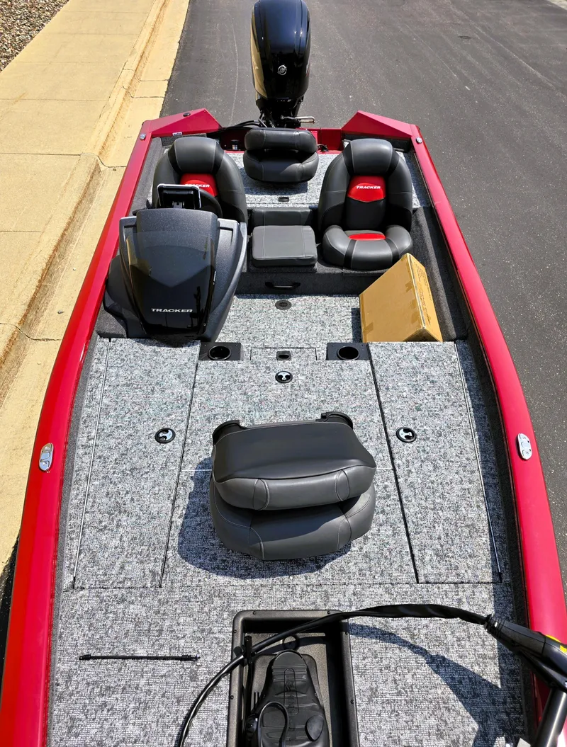 Slide: The Image of 2025 Tracker Pro Team 175 boat with red trim and spacious seating. - 2