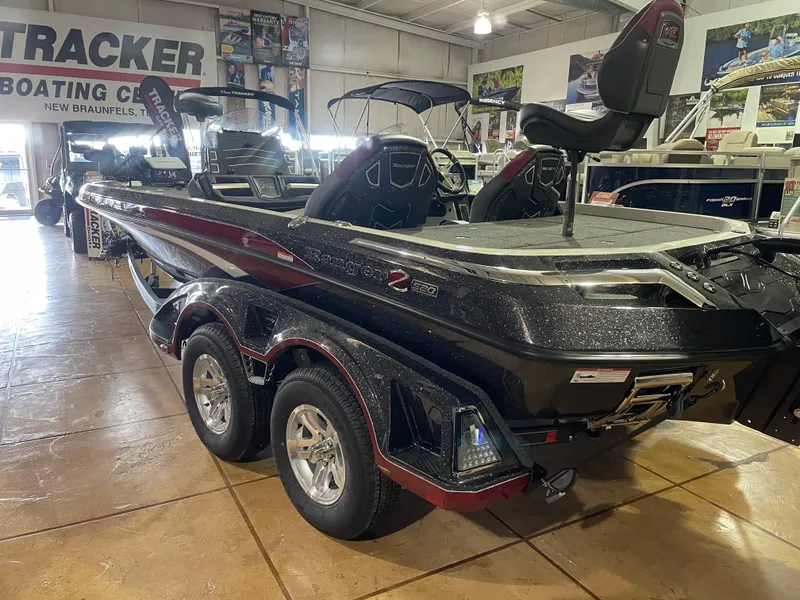Slide: The Image of 2025 Ranger Z520 boat in showroom, featuring sleek design and dual-axle trailer. - 1