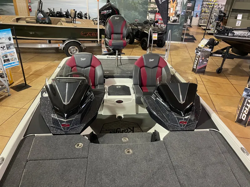 Slide: The Image of 2025 Ranger Z520 boat interior with red and black seats in showroom. - 14