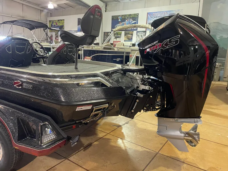 Slide: The Image of 2025 Ranger Z520 boat with Mercury Pro XS engine in showroom. - 2