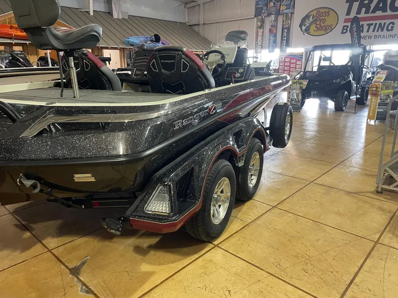 Slide: The Image of 2025 Ranger Z520 boat in showroom, featuring sleek design and dual-axle trailer. - 5