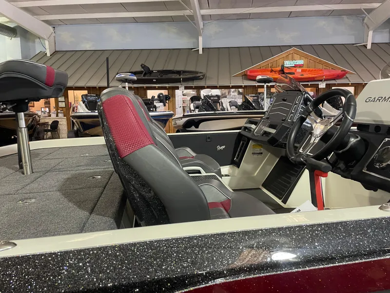 Slide: The Image of 2025 Ranger Z520 boat interior with red and black seats, steering wheel, and dashboard. - 9