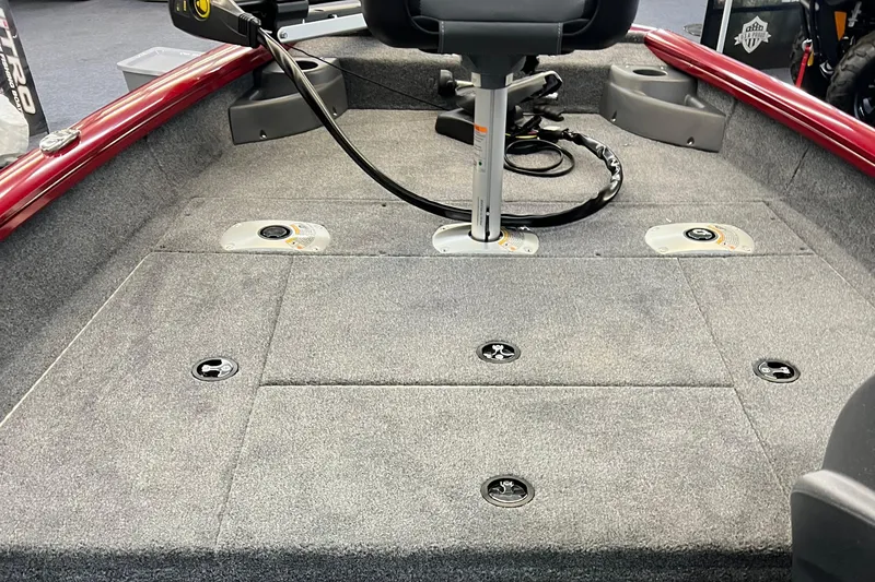Slide: The Image of 2025 Tracker Pro Team 175 Crappie Edition boat interior with gray carpet and seating. - 10