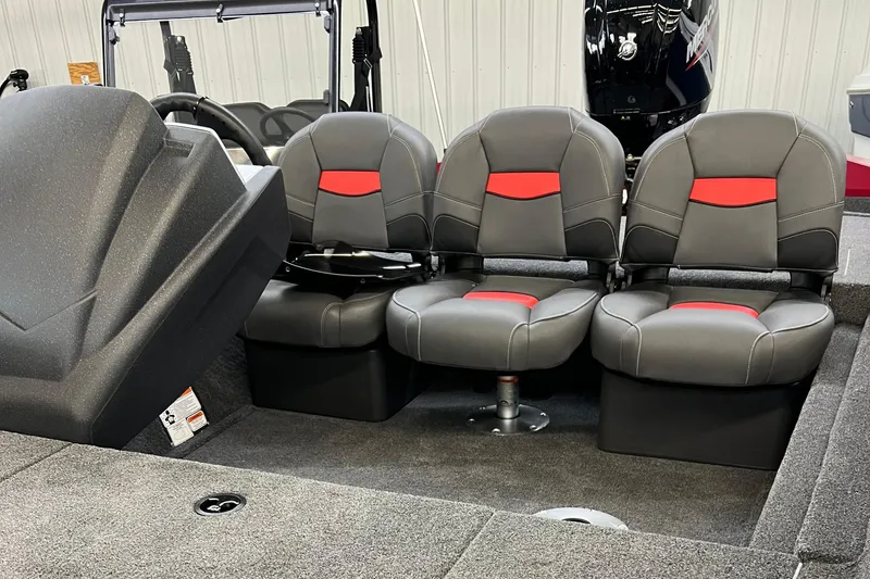 Slide: The Image of 2025 Tracker Pro Team 175 Crappie Edition boat interior with three gray and red seats. - 11