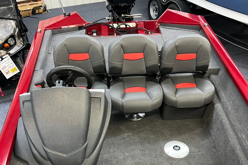 Slide: The Image of 2025 Tracker Pro Team 175 Crappie Edition boat interior with gray and red seating. - 12