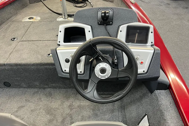 Slide: The Image of 2025 Tracker Pro Team 175 Crappie Edition boat dashboard with steering wheel and controls. - 5