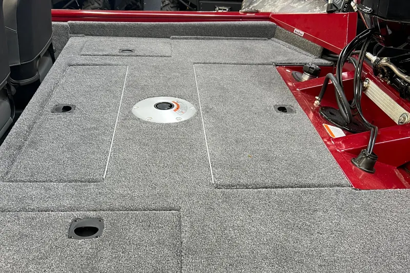 Slide: The Image of 2025 Tracker Pro Team 175 Crappie Edition boat deck with gray carpet and red accents. - 9