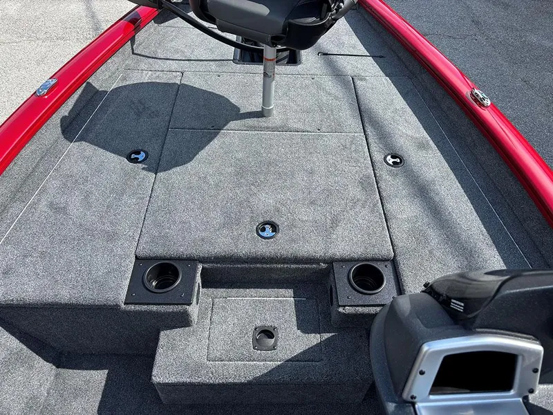 Slide: The Image of 2025 Tracker Pro Team 175 boat interior with gray carpet and red accents. - 13