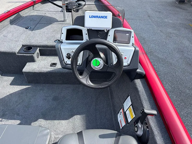 Slide: The Image of 2025 Tracker Pro Team 175 boat dashboard with Lowrance electronics and steering wheel. - 17