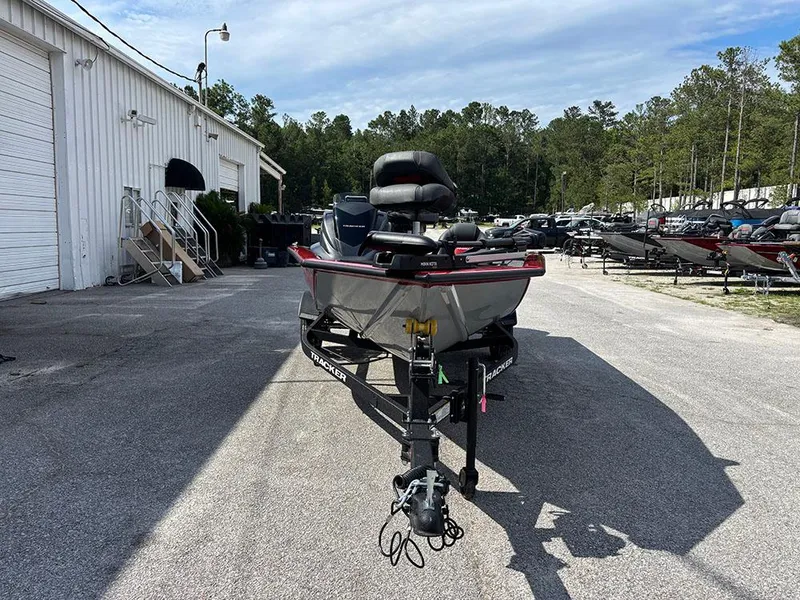 Slide: The Image of 2025 Tracker Pro Team 175 boat parked outdoors at a dealership. - 2