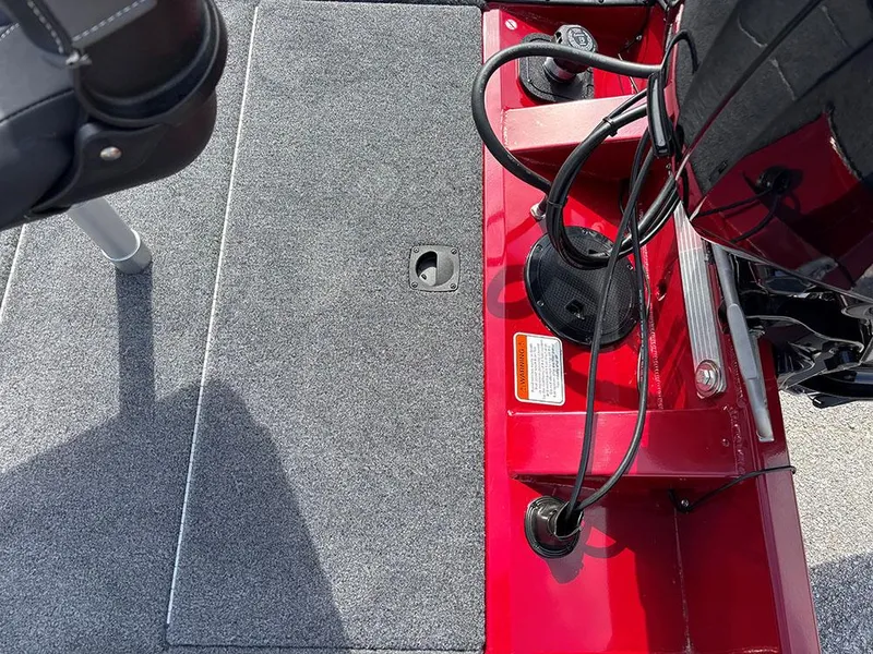 Slide: The Image of 2025 Tracker Pro Team 175 boat interior with red accents and carpeted flooring. - 22