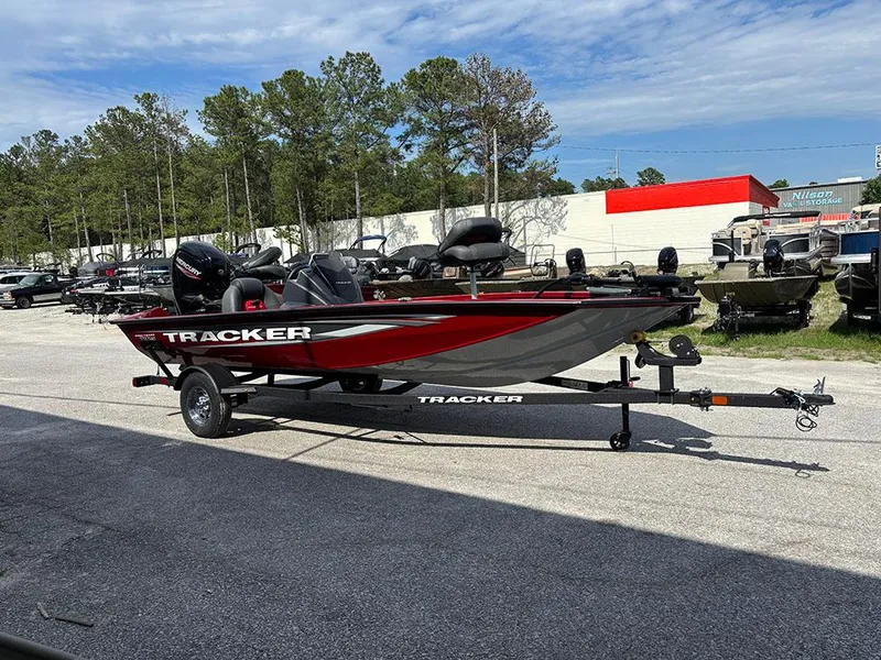 Slide: The Image of 2025 Tracker Pro Team 175 boat on trailer, parked outdoors under a clear sky. - 3
