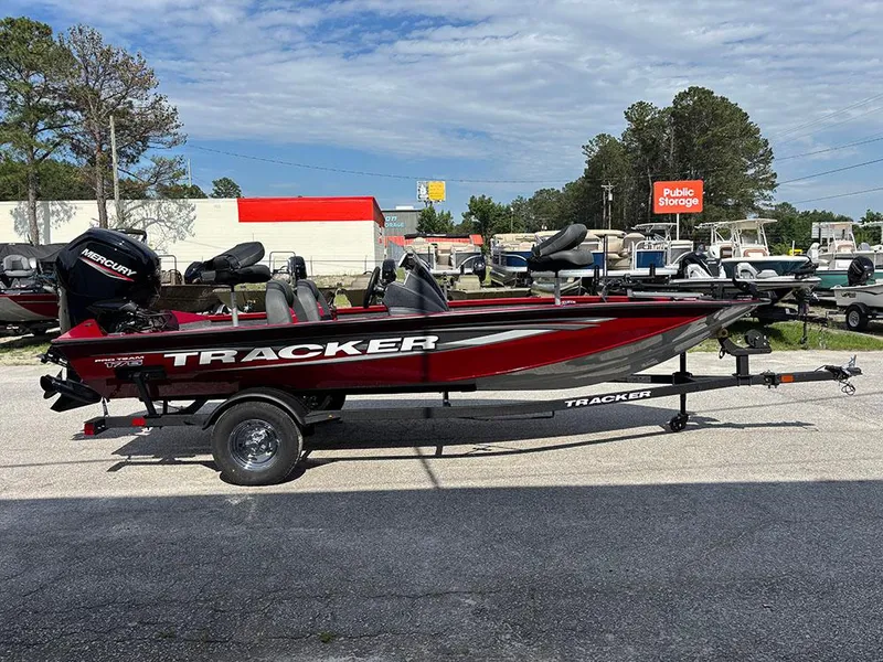 Slide: The Image of 2025 Tracker Pro Team 175 boat, red, on trailer, parked outdoors. - 4