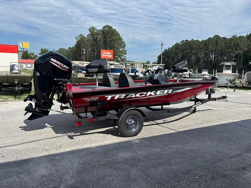 Slide: The Image of 2025 Tracker Pro Team 175 boat on trailer, red color, parked outdoors. - 5