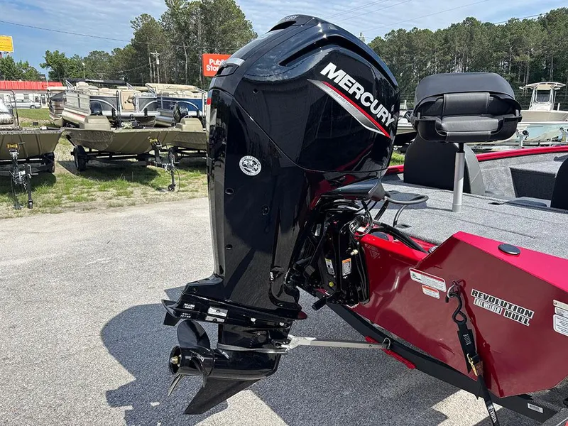 Slide: The Image of 2025 Tracker Pro Team 175 boat with Mercury outboard motor, parked outdoors. - 8