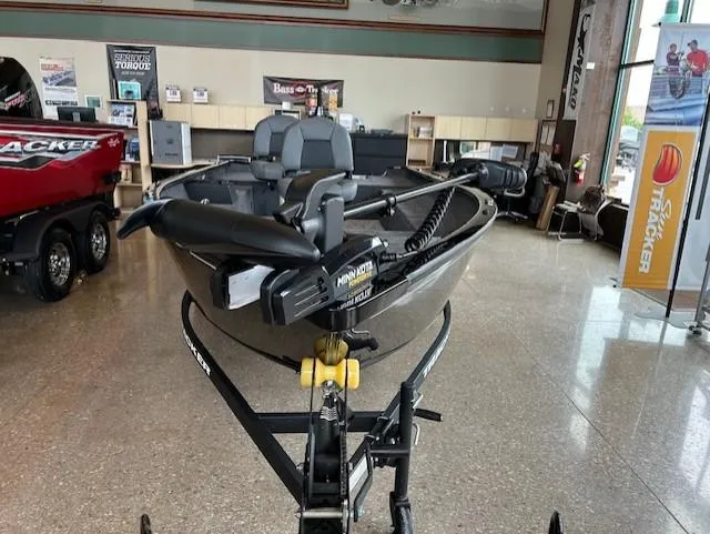 Slide: The Image of 2025 Tracker Super Guide V-16 T fishing boat displayed indoors. - 2