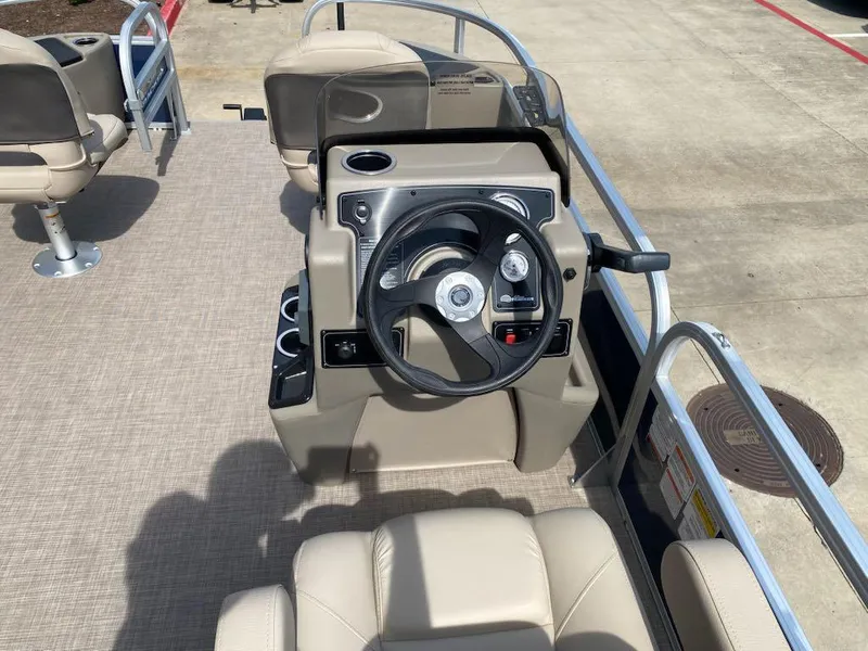 Slide: The Image of 2025 Sun Tracker Bass Buggy 18 DLX boat interior with steering console and seating. - 6