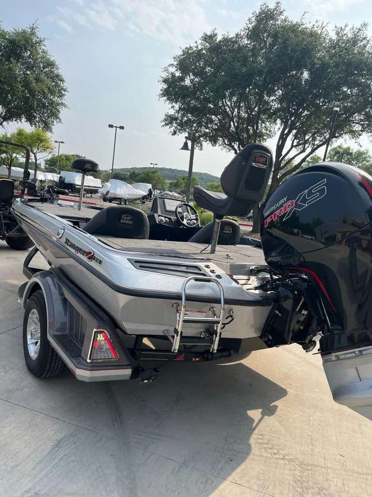 Slide: The Image of 2025 Ranger Z518 Cup-Equipped boat with Mercury Pro XS engine, parked outdoors. - 4