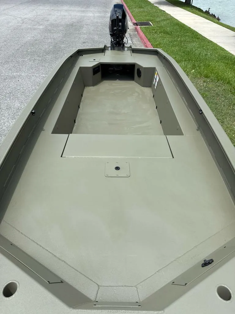 Slide: The Image of 2025 Tracker Grizzly 1650 T Prairie Wings Edition boat, featuring spacious deck and sleek design. - 4