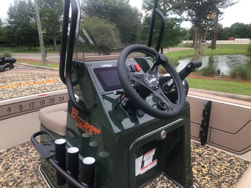 Slide: The Image of 2025 Mako 18 Pro Skiff Backwater Edition boat console with steering wheel and controls. - 13