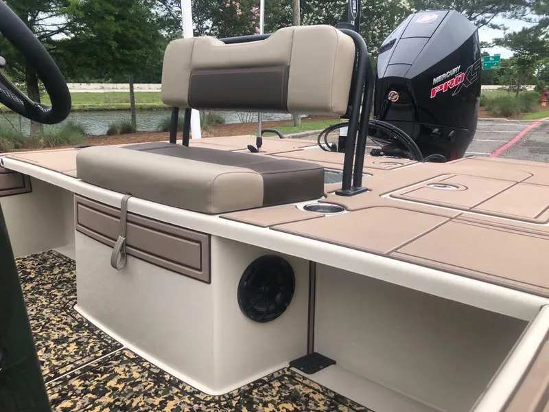 Slide: The Image of 2025 Mako 18 Pro Skiff Backwater Edition boat interior with seating and motor. - 14