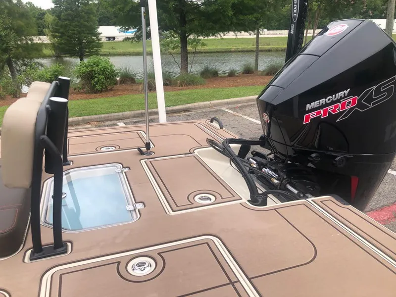 Slide: The Image of 2025 Mako 18 Pro Skiff Backwater Edition with Mercury Pro XS engine, parked near a lake. - 15