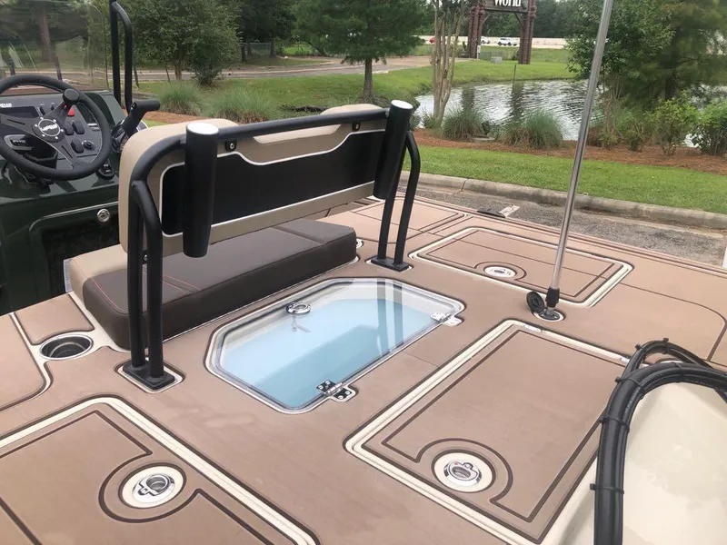 Slide: The Image of 2025 Mako 18 Pro Skiff Backwater Edition boat interior with seating and storage compartments. - 16