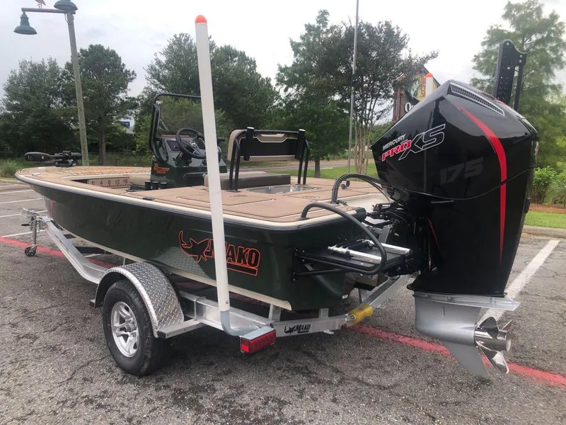 Slide: The Image of 2025 Mako 18 Pro Skiff Backwater Edition with powerful outboard motor on trailer. - 4