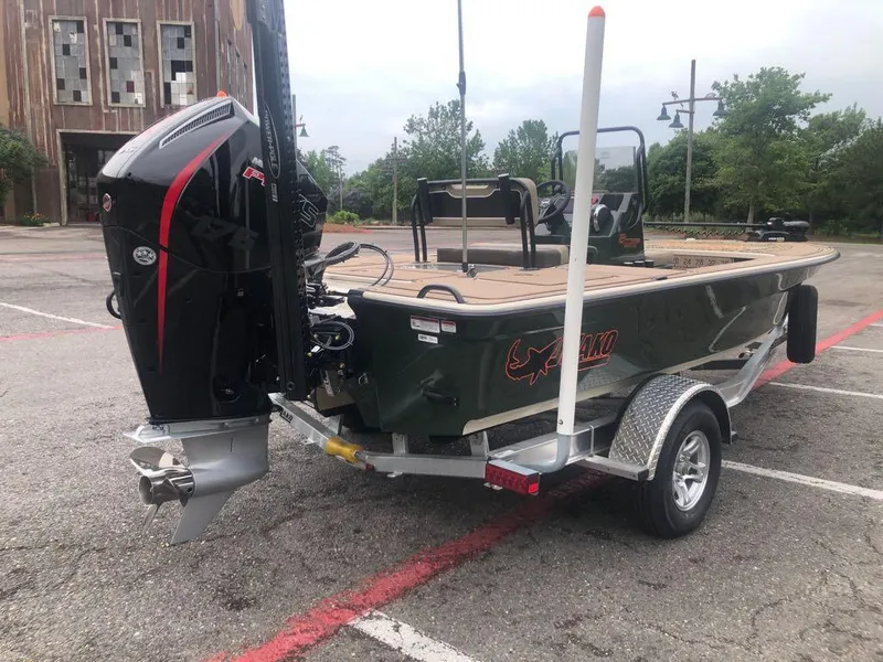 Slide: The Image of 2025 Mako 18 Pro Skiff Backwater Edition boat on trailer in parking lot. - 6