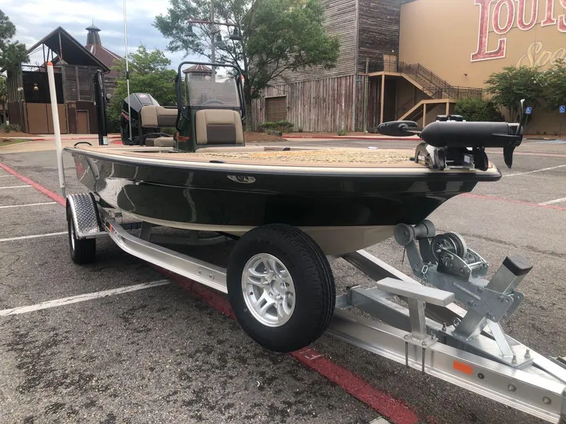 Slide: The Image of 2025 Mako 18 Pro Skiff Backwater Edition on trailer in parking lot. - 8