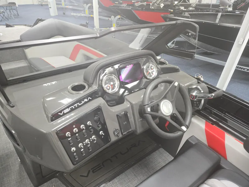 Slide: The Image of 2025 Princecraft Ventura 230 WRL boat dashboard with modern controls and steering wheel. - 10
