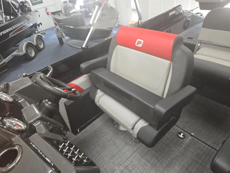 Slide: The Image of 2025 Princecraft Ventura 230 WRL boat interior with steering wheel and cushioned seating. - 12