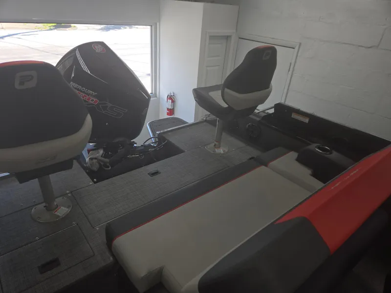 Slide: The Image of 2025 Princecraft Ventura 230 WRL boat interior with seating and motor in showroom. - 20