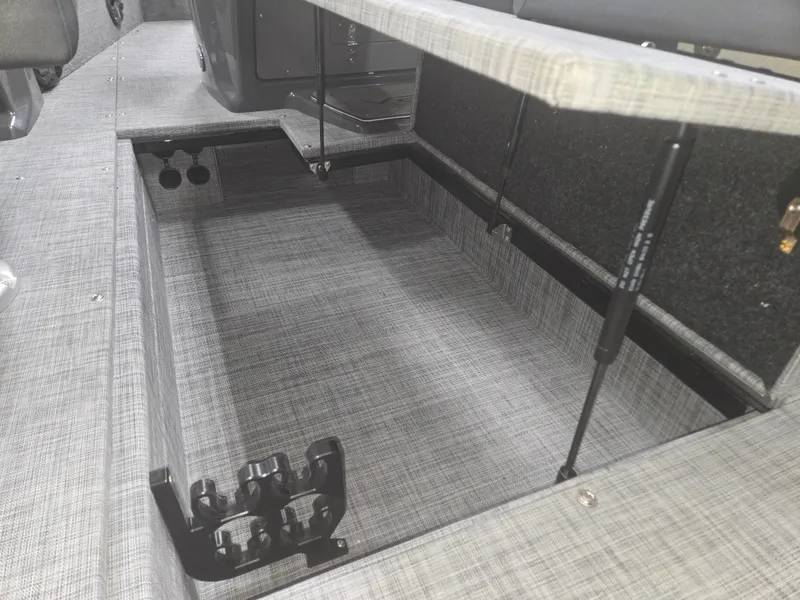 Slide: The Image of Storage compartment in 2025 Princecraft Ventura 230 WRL boat, featuring hydraulic lift supports. - 23