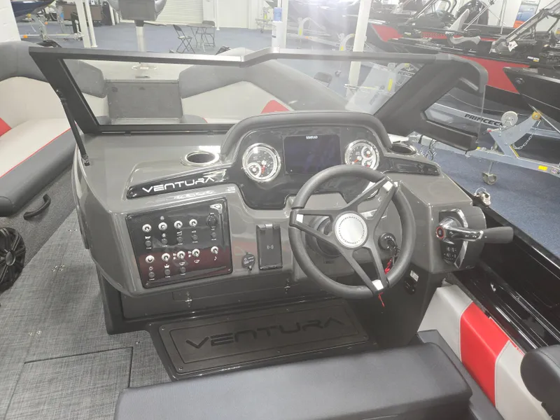Slide: The Image of 2025 Princecraft Ventura 230 WRL boat dashboard with steering wheel and control panel. - 24