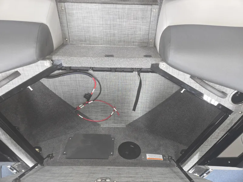 Slide: The Image of 2025 Princecraft Ventura 230 WRL boat storage compartment with wiring and seating. - 25