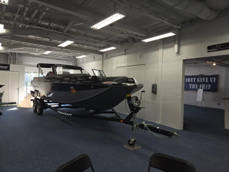 Slide: The Image of 2025 Princecraft Ventura 230 WRL boat displayed indoors on a trailer. - 3
