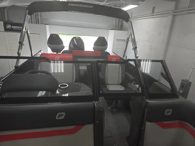 Slide: The Image of 2025 Princecraft Ventura 230 WRL boat interior with seating and windshield in showroom. - 6