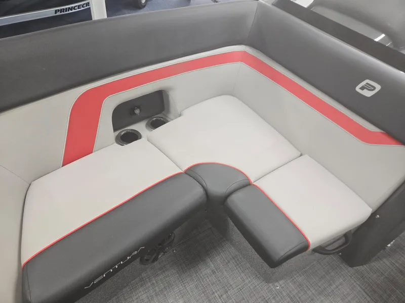 Slide: The Image of 2025 Princecraft Ventura 230 WRL boat interior with red and gray seating and cup holders. - 8