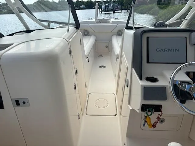 Slide: The Image of 2016 Grady-White Freedom 275 boat interior with Garmin navigation system. - 13