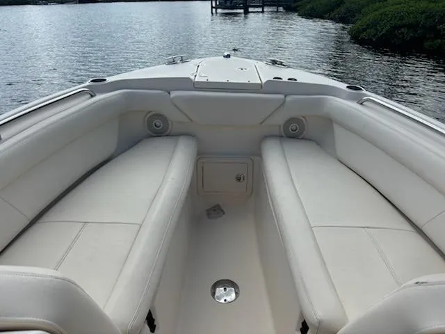 Slide: The Image of 2016 Grady-White Freedom 275 boat interior with white seating, dockside view. - 14