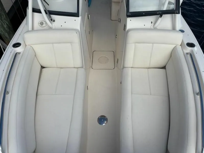 Slide: The Image of 2016 Grady-White Freedom 275 boat interior with white cushioned seating. - 15