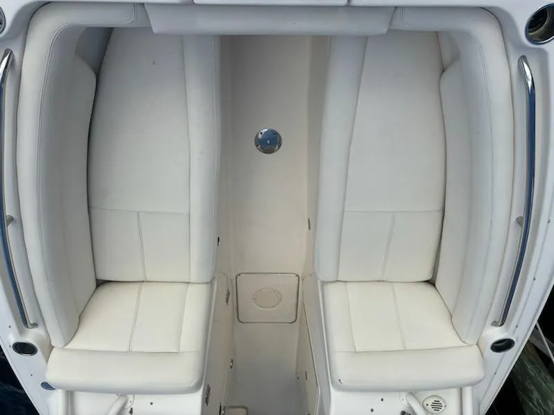 Slide: The Image of 2016 Grady-White Freedom 275 boat interior with white cushioned seating. - 16