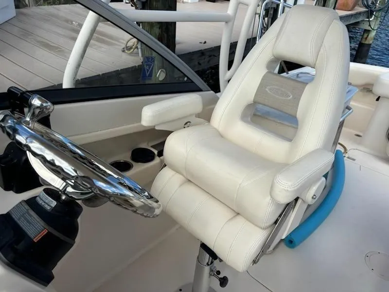 Slide: The Image of Captain's chair and steering wheel on 2016 Grady-White Freedom 275 boat. - 18